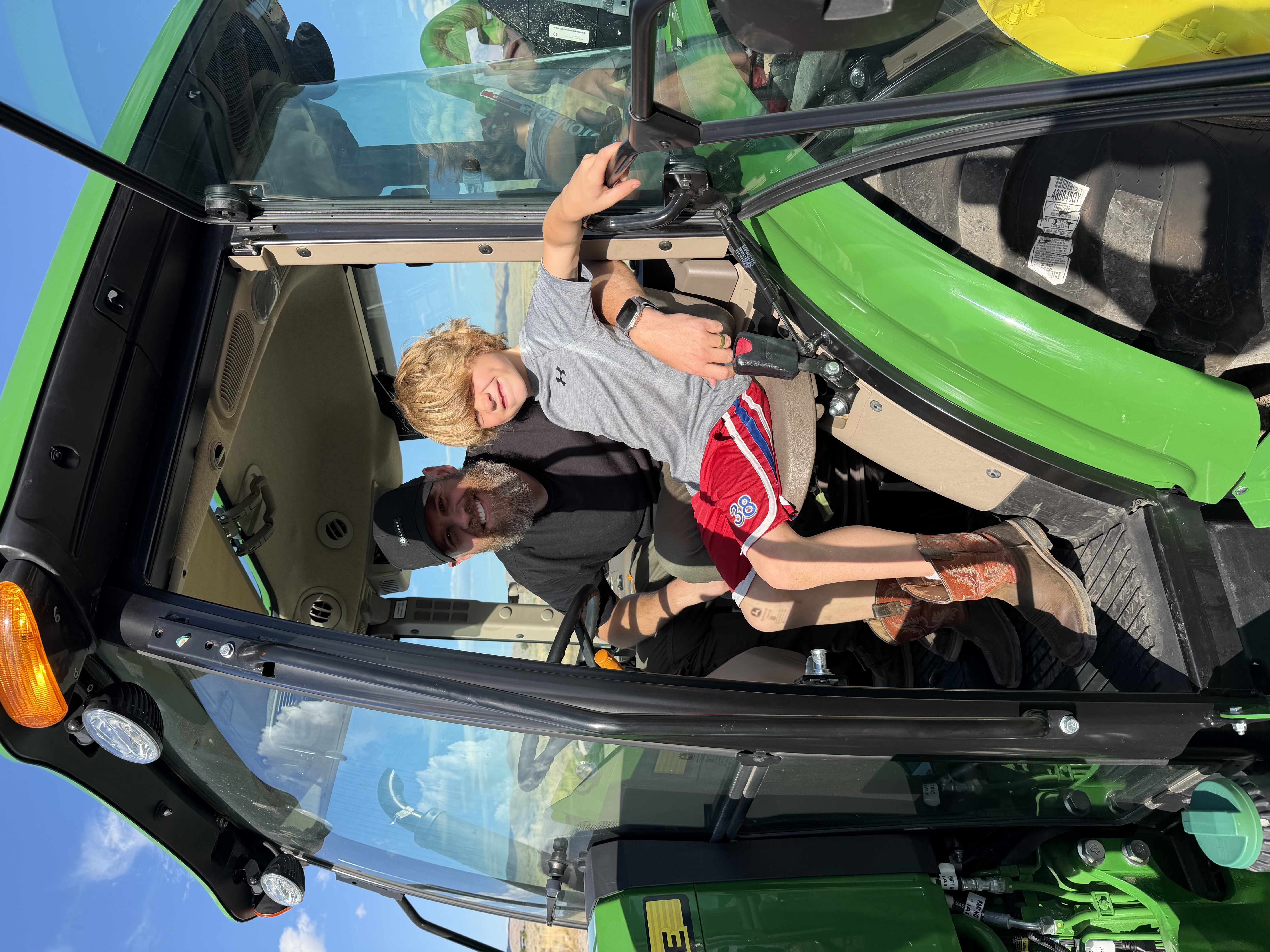 Kids learning to drive tractor